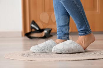 Legs of woman wearing slippers in hallway. Concept of day off�