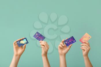 Female hands with credit cards on color background�