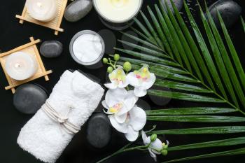 Beautiful spa composition with candles on dark background�