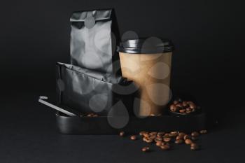 Blank coffee bags and cup on dark background�