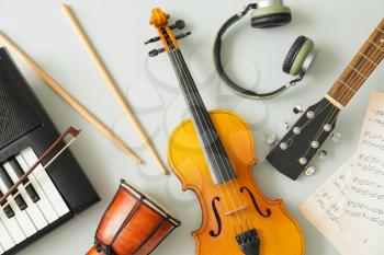 Different musical instruments and music notes on light background�