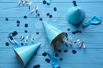 Composition with party hats on color wooden background�