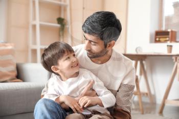 Happy father and his little son at home�