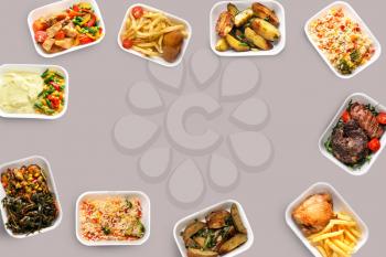 Containers with delicious food on grey background. Delivery service�
