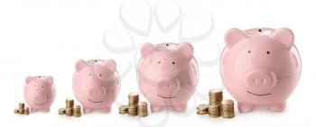 Cute piggy banks of different sizes on white background�
