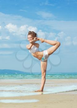 Royalty Free Photo of a Woman Doing Yoga on the Beach