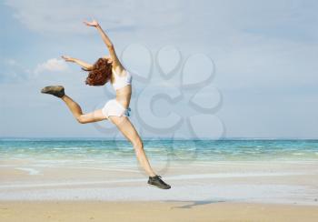 Royalty Free Photo of a Woman Running at the Beach