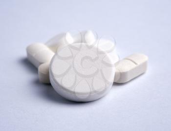 Some of White pills on a light background Shallow DOF