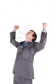 Happy young businessman with his hands up on white background 