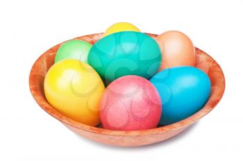 multicolored Easter eggs on the wooden plate isolated on a white background