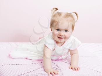 Portrait of beautiful baby girl on a light background