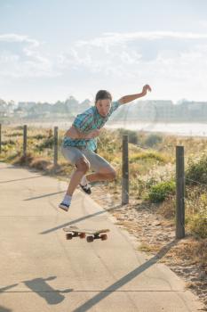 teenager have fun and high jumping with skateboard