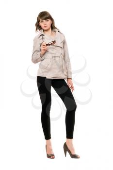 Royalty Free Photo of a Girl in a Beige Jacket and Black Pants