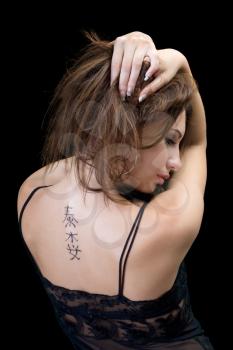Royalty Free Photo of a Woman Showing the Tattoo on Her Back