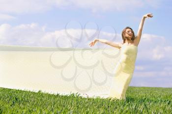 Expressive charming girl in a green field 