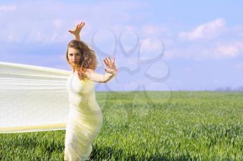 Cute flexible young woman wrapped in yellow cloth   