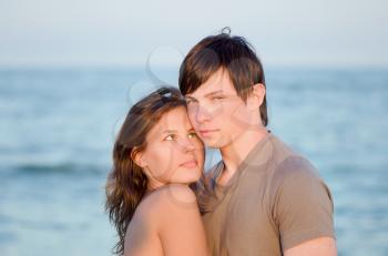 Closeup portrait of a sensual young couple on the beach