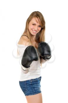 Playful young blonde in blue jeans and white blouse with boxing gloves. Isolated 