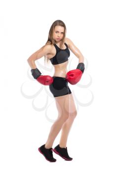 Young blonde posing in black sportswear with red boxing gloves. Isolated on white