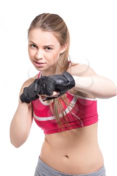 Portrait of young woman boxing in the studio. Isolated on white