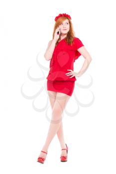 Pretty young woman wearing red dress with a phone. Isolated on white