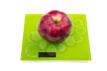 Juicy ripe red apple on scales. Isolated