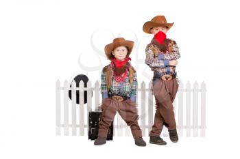 Two boys wearing cowboy costumes. Isolated on white