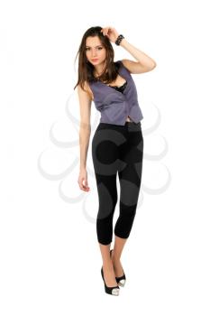 Young sexy brunette wearing tight black leggings and grey vest. Isolated on white