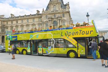 PARIS, FRANCE - JULY 10:Tourists bus in the heart of Paris on July 10, 2012. Paris is one of the most visited cities in the world