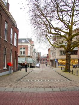 GORINCHEM, THE NETHERLANDS - FEBRUARY 16, 2012 : People walk in the Dutch town in Gorinchem. Netherlands.  The city is located in the province of South Holland. Population - about 33,000 people