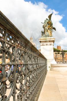 ROME, ITALY - MAY 03, 2014: Lattice fence and a statue of the monument to Victor Emmanuel II. Piazza Venezia, Rome , Italy