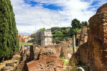 ROME, ITALY - MAY 04, 2014: Picturesque ruins on the background of Arches of Constantine in Rome, Italy