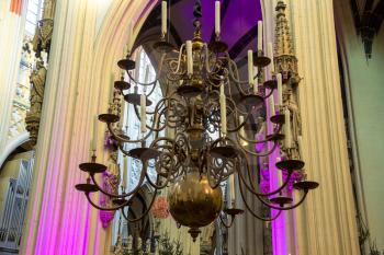 Chandelier with candles in the cathedral Dutch city of Den Bosch