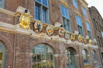 Amsterdam, the Netherlands -October 03, 2015: Old building with coat of arms on facade in the historic city center.