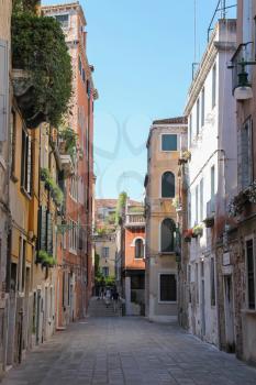 Venice, Italy - August 13, 2016: Tourists on narrow street of historic center in Venice, San Marco