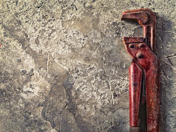 old wrench on concrete in vintage style