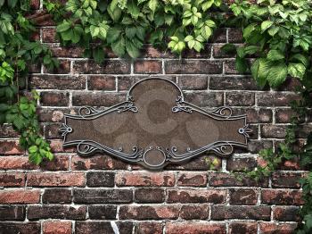 Vintage cast metal plate and climbing plant on the old brick wall