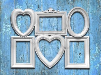 Decorative white photo frames on a blue wooden background
