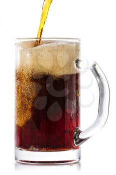 Dark beer pouring into glass. Isolated on white background.
