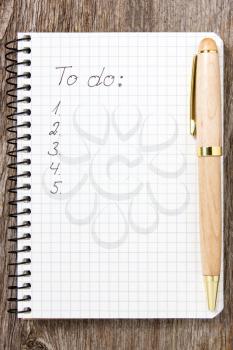 Pen and notepad with a to-do list
