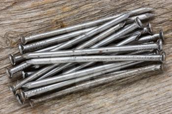 Pile of nails on the  wooden background