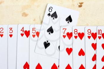 Playing cards. Many red hearts with one card of black spade.