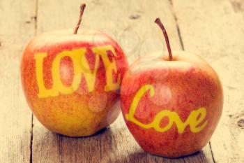 Partnership and friendship concept. Two apples with the words LOVE.