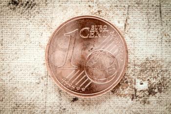 One Euro cent on old canvas background 