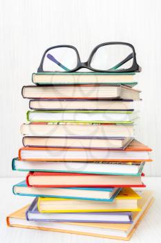 Stack of books with a eyeglasses on top.Reading, literature,education concept.