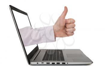 Businessman thumbs up through a laptop, isolated on white background