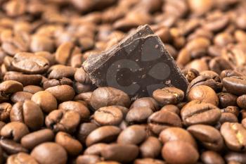 Fresh roasted coffee beans and piece of  chocolate