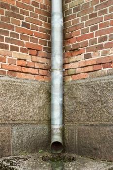 Vintage brick wall texture with drainpipe