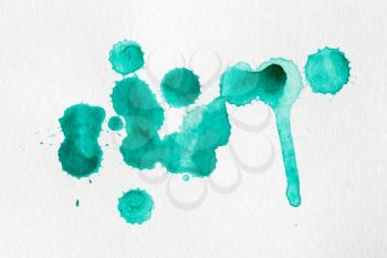 Splatter of watercolor paint on a white paper