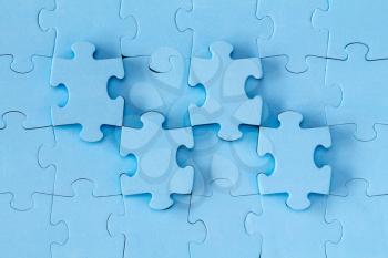 Abstract background made of blue puzzle pieces